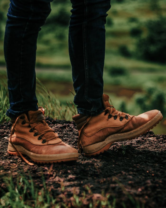 Close-up of brown leather boots in a rugged outdoor setting, perfect for hiking and adventure.